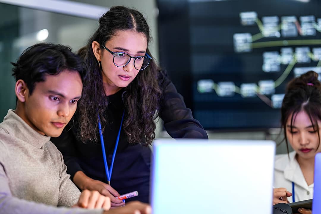 A focused group of developers working on a coding project.